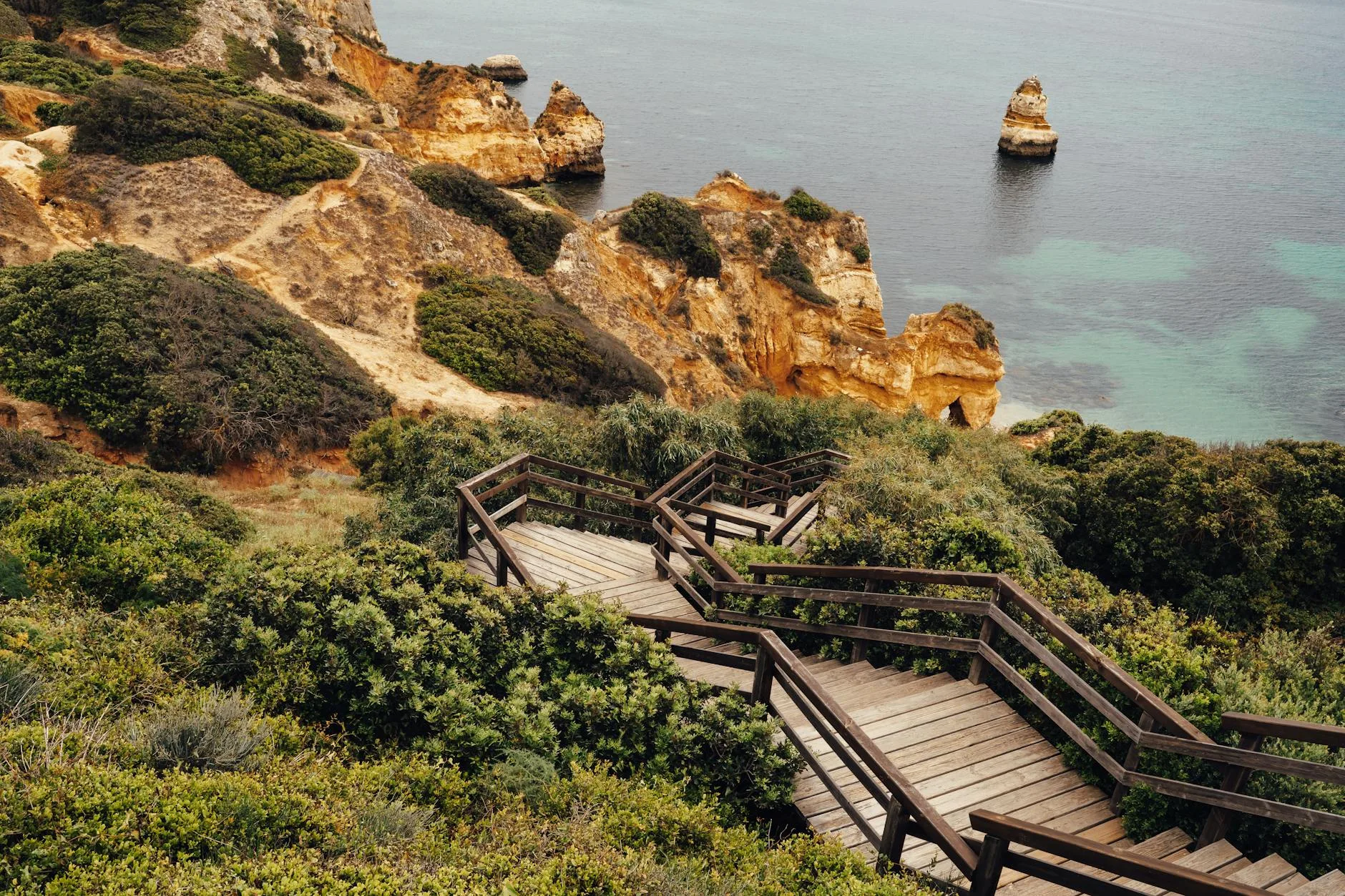 Rugged coastal cliffs overlooking a sparkling blue European sea on a sunny day