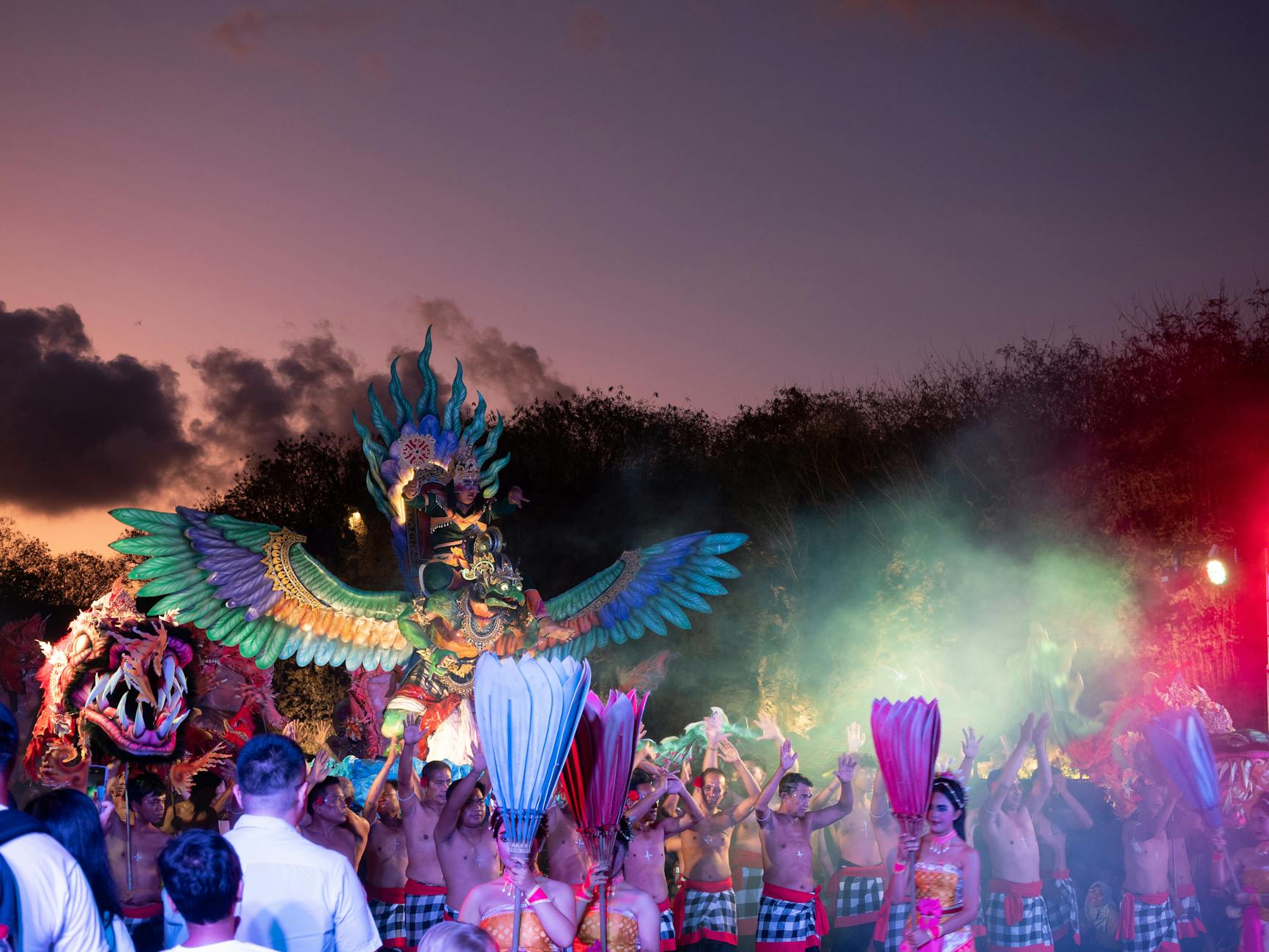 Balinese dancers in ornate golden costumes performing at a vibrant outdoor temple festival