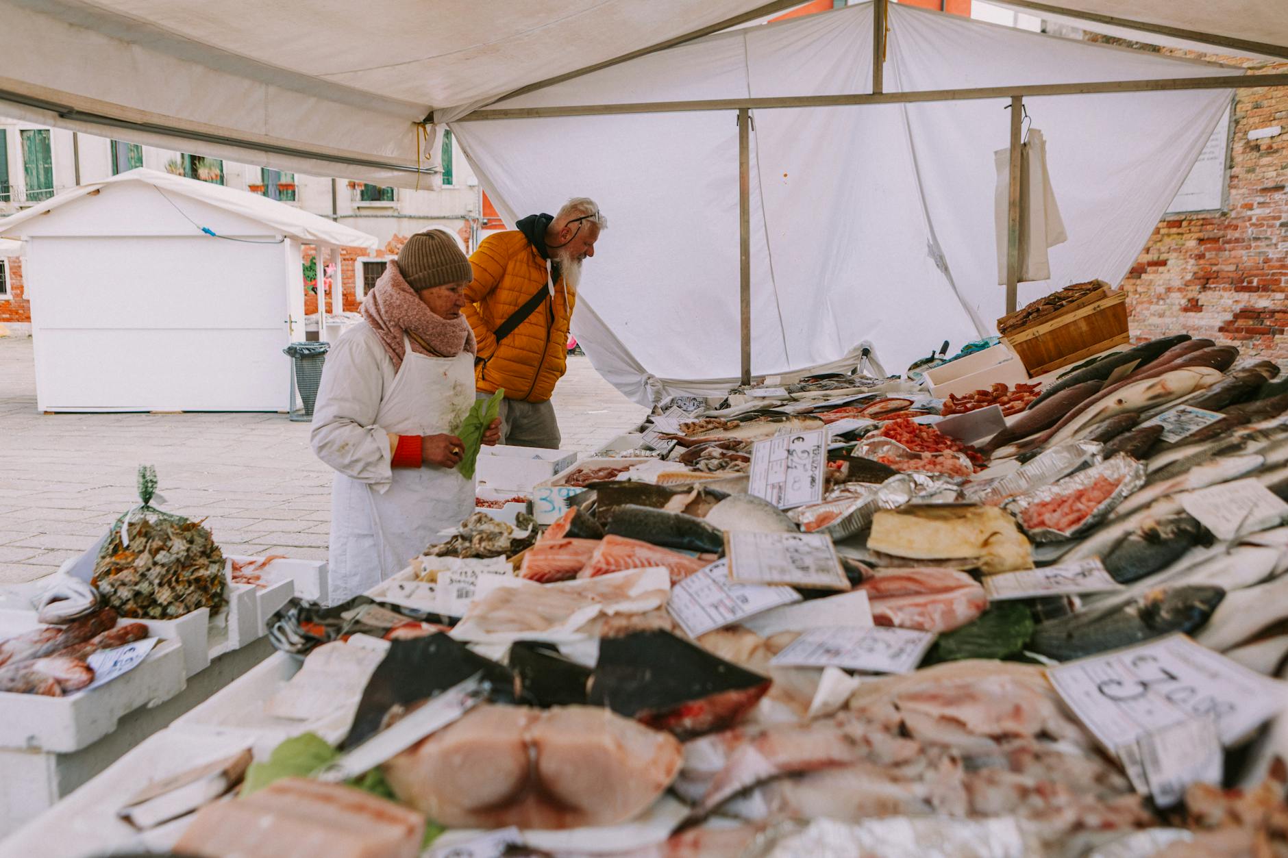 Colorful stalls of fresh produce and local delicacies at a bustling European market