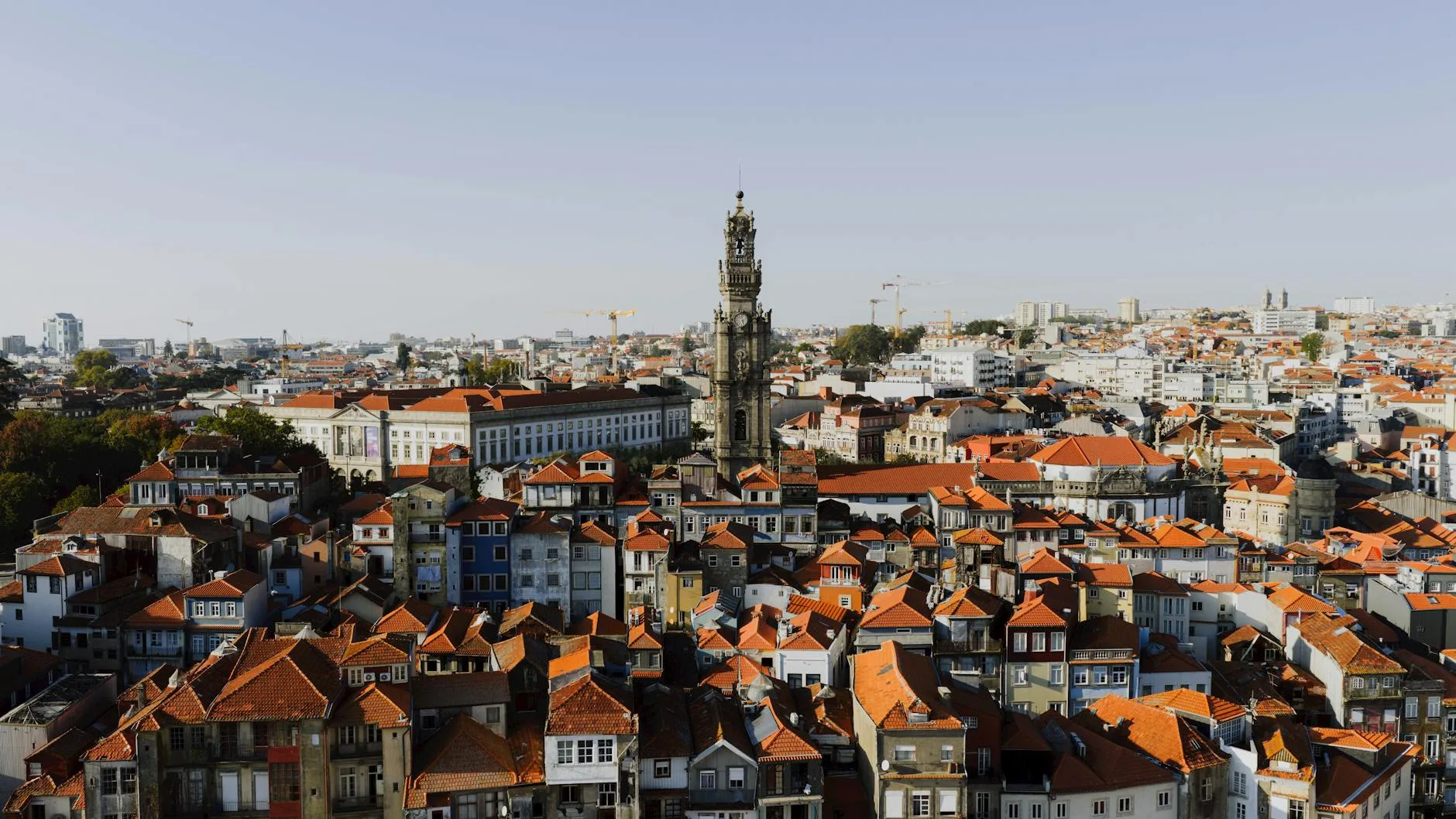 Sunlit cobblestone street in a quiet Portuguese village with terracotta rooftops