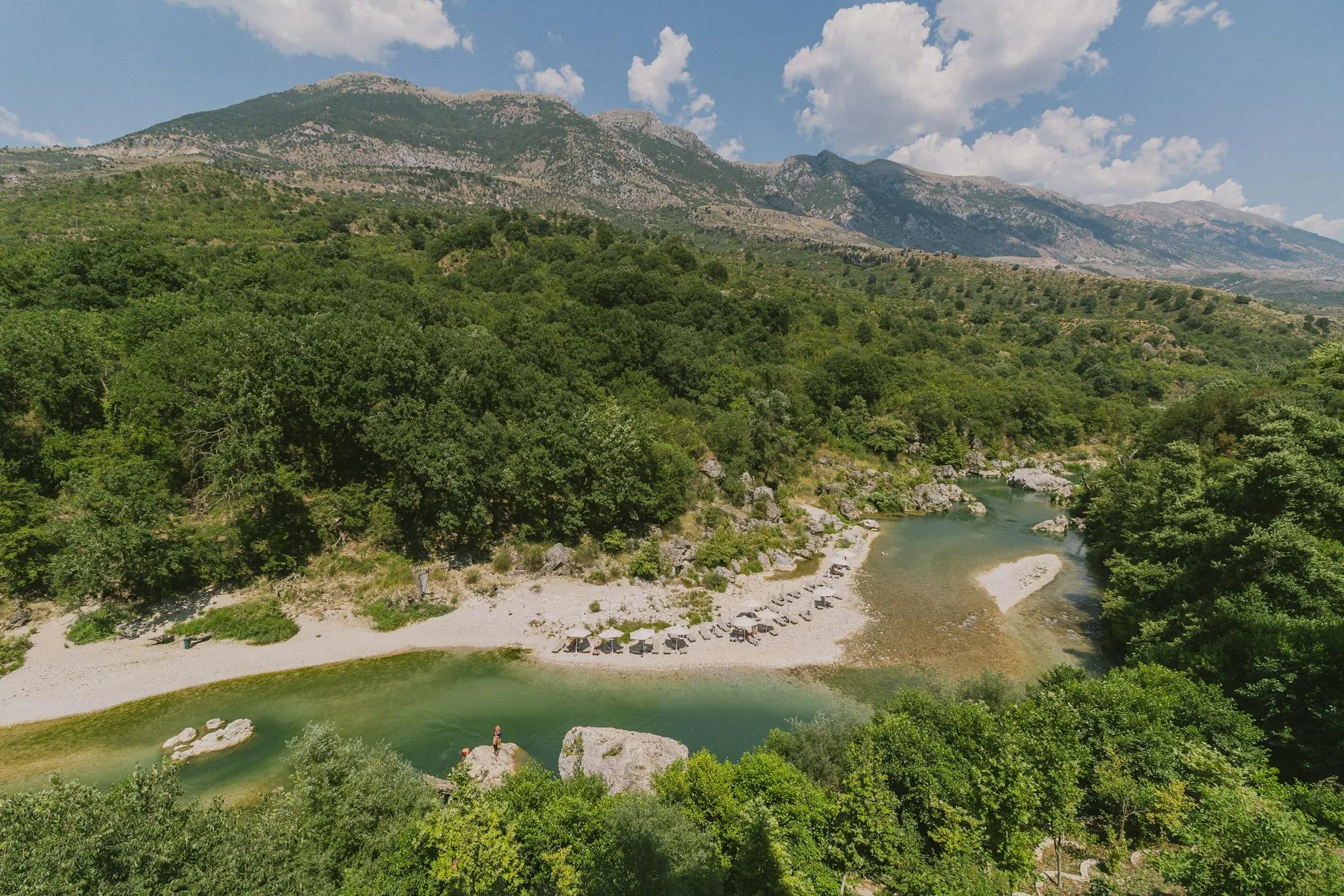 Sunlit Albanian Riviera coastline with turquoise waters and rugged cliffs