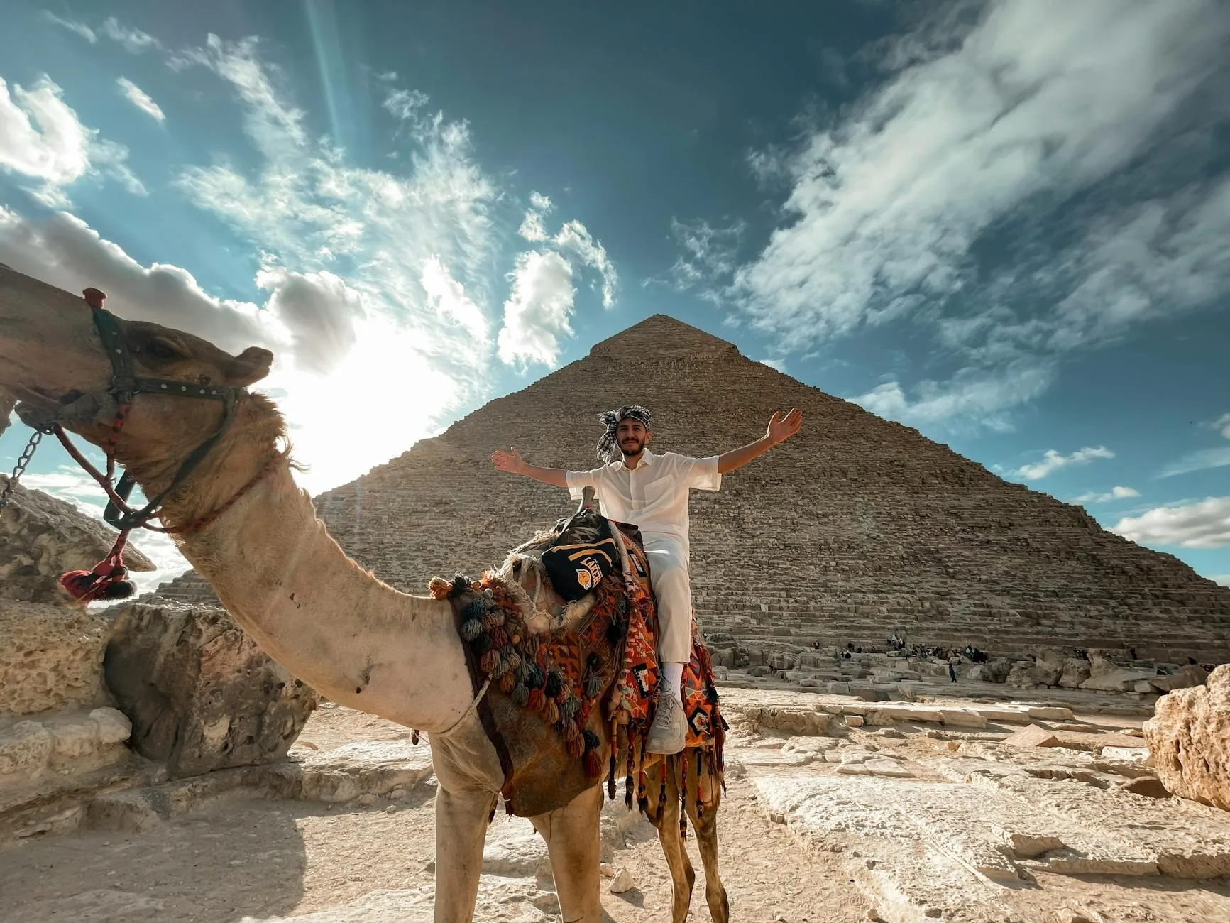 Sunlit pyramids of Giza rising above golden desert sands near Cairo, Egypt