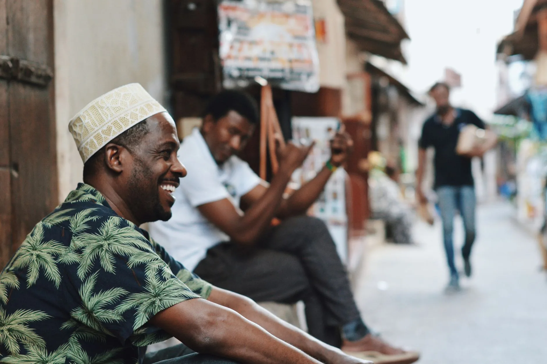 Traveler sharing a warm laugh with locals at a bustling street market abroad