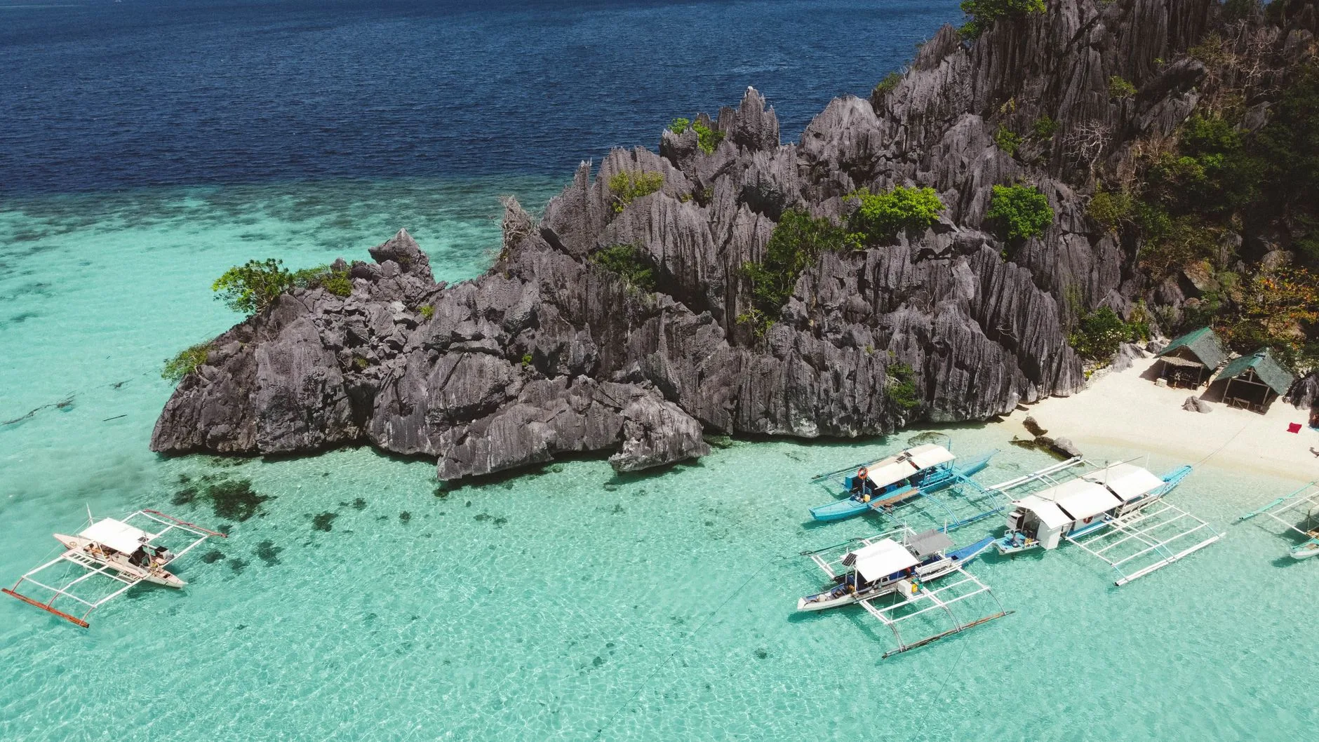 Turquoise waters and limestone cliffs of the Philippines' islands under golden sunlight