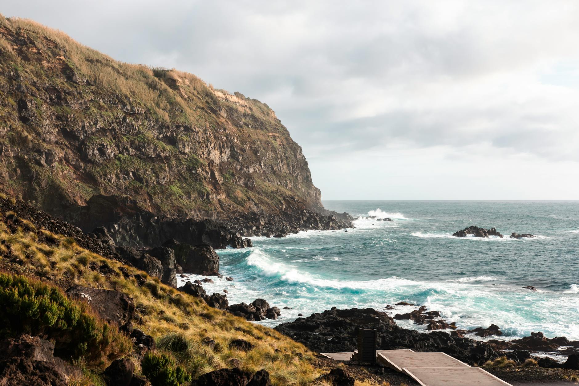Mist-draped volcanic crater lake surrounded by lush green hills, São Miguel, Azores