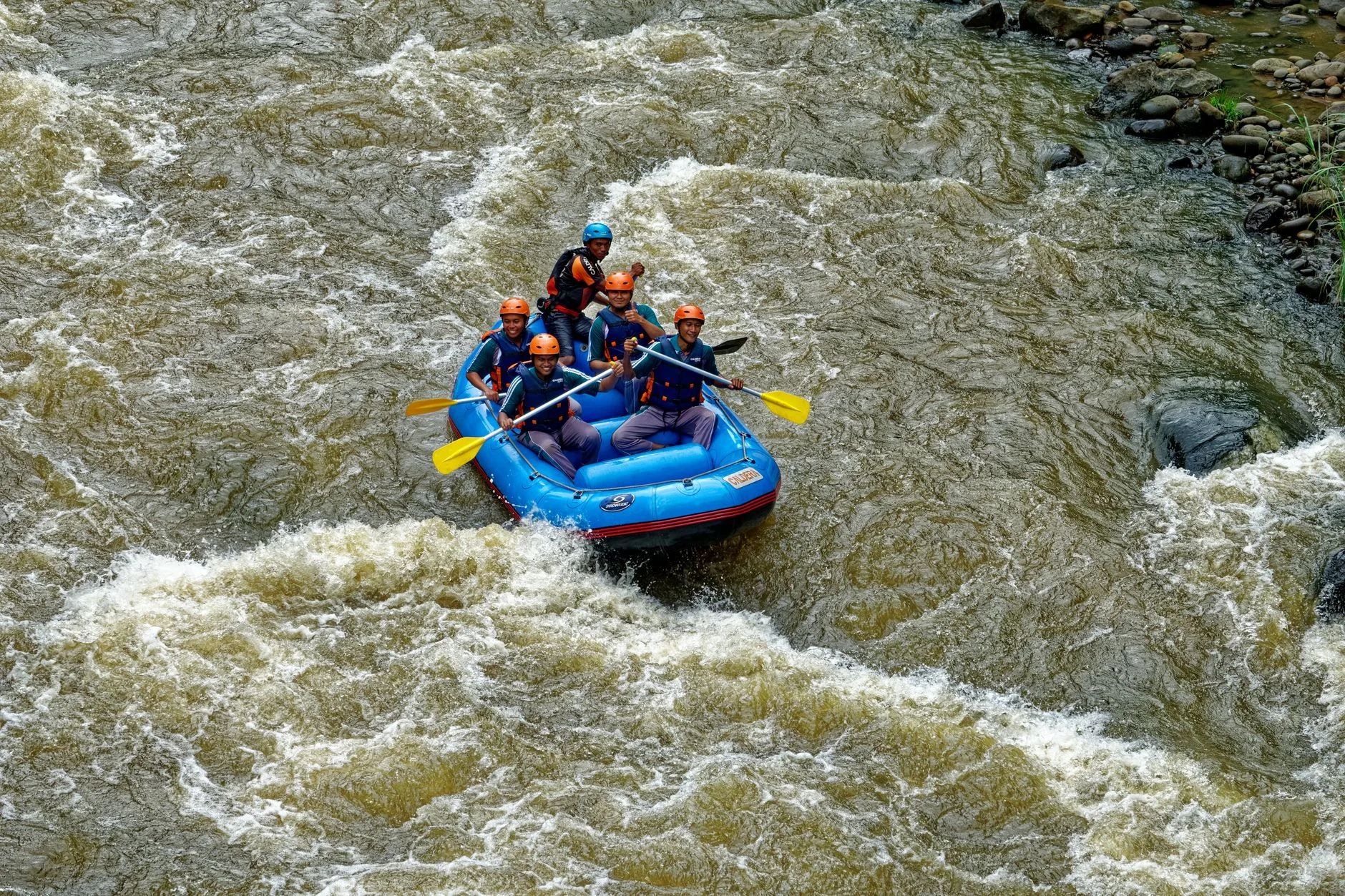 Rafters navigating churning rapids through Costa Rica's lush jungle river