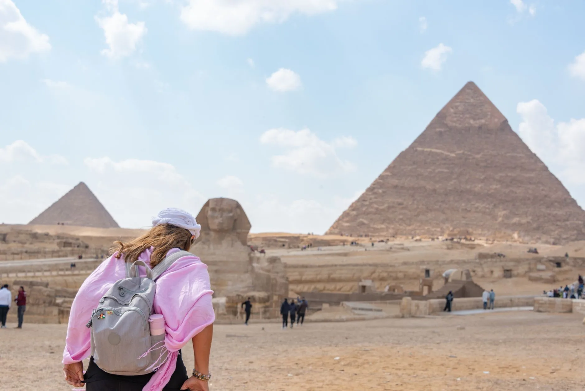 Sunlit Egyptian souq with colorful spices, bustling locals, and ancient architecture