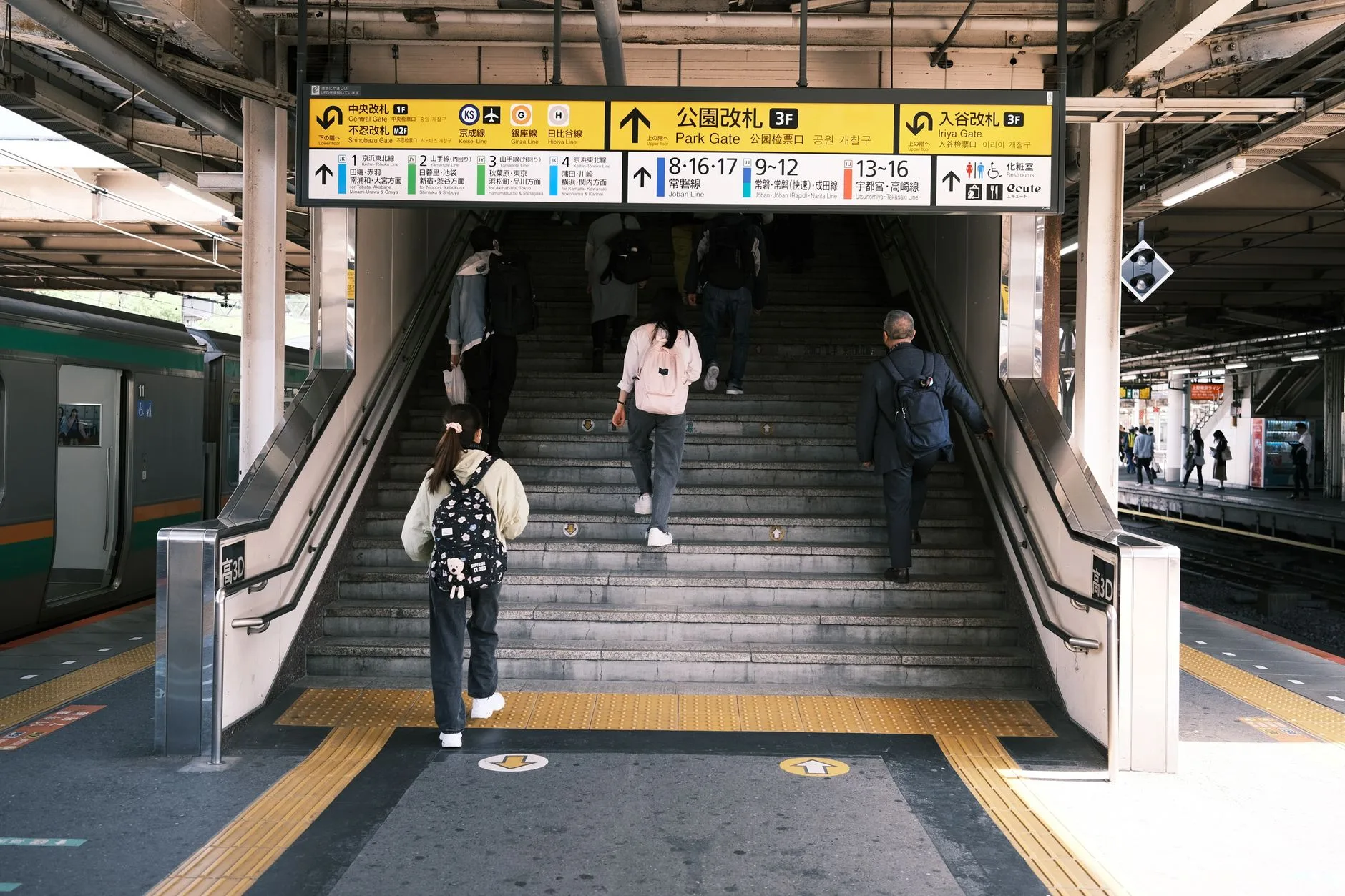 Bustling Tokyo street at night with glowing neon signs and crowds of pedestrians