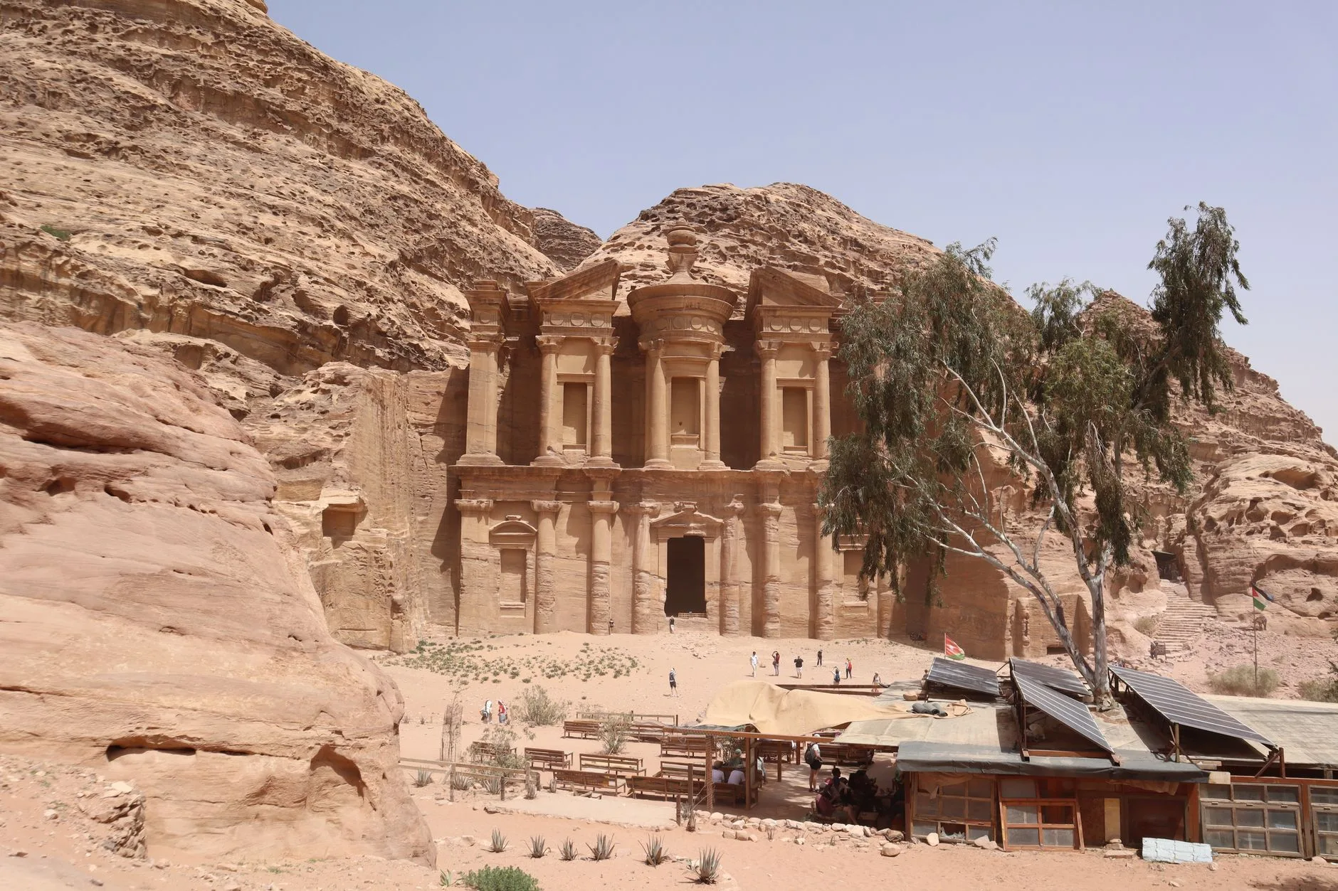 Petra's rose-red Treasury carved into sandstone cliffs under a vivid blue Jordanian sky