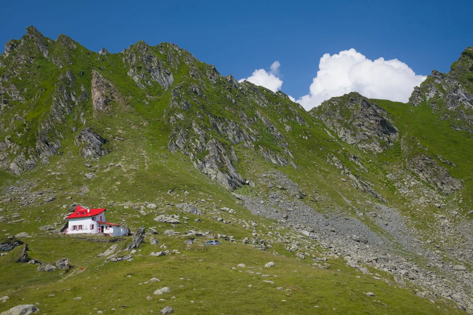 Hiker on a misty Carpathian mountain trail surrounded by dense Romanian forests