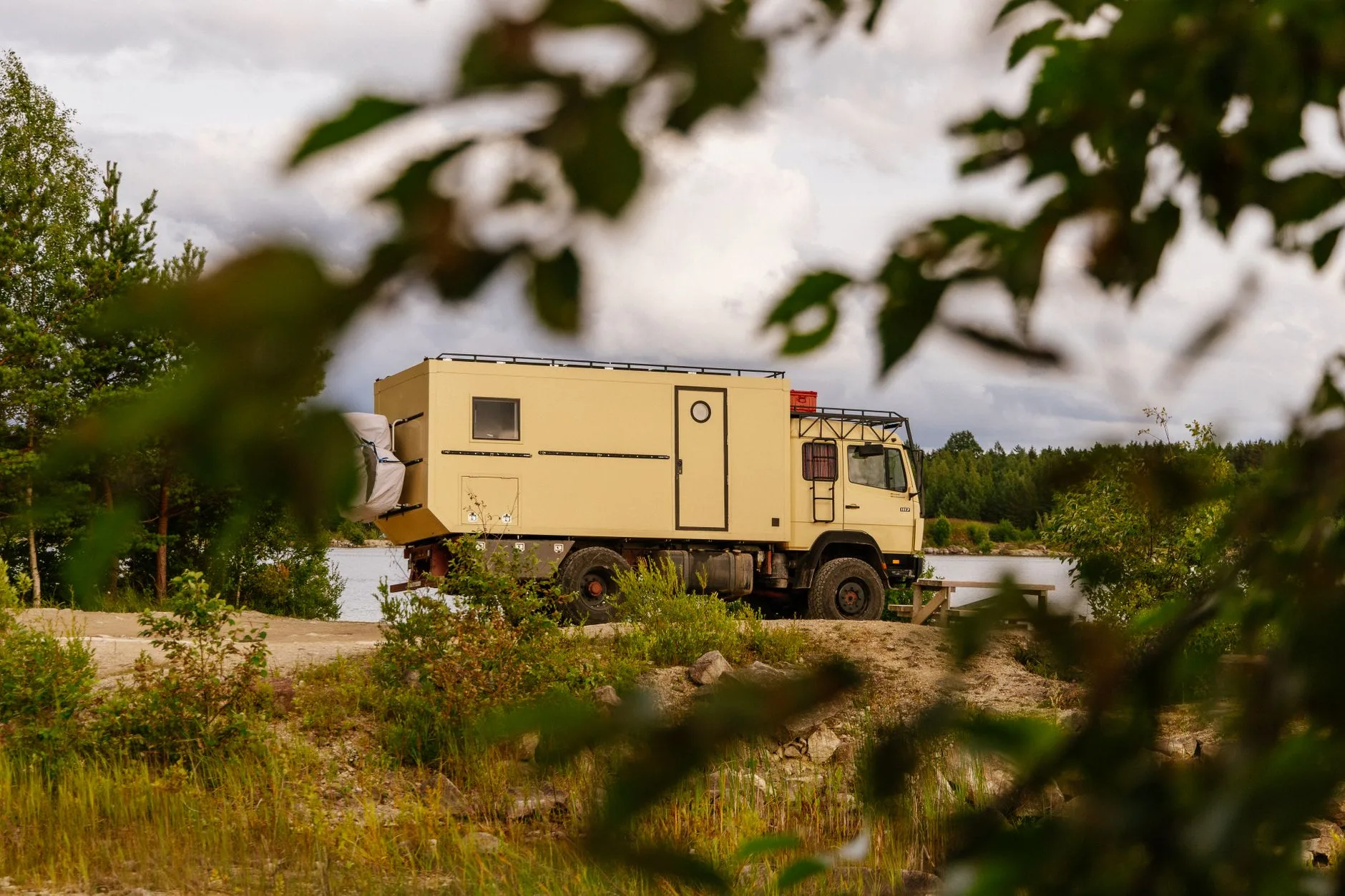 Dusty overland trail winding through mountains connecting European and Asian landscapes