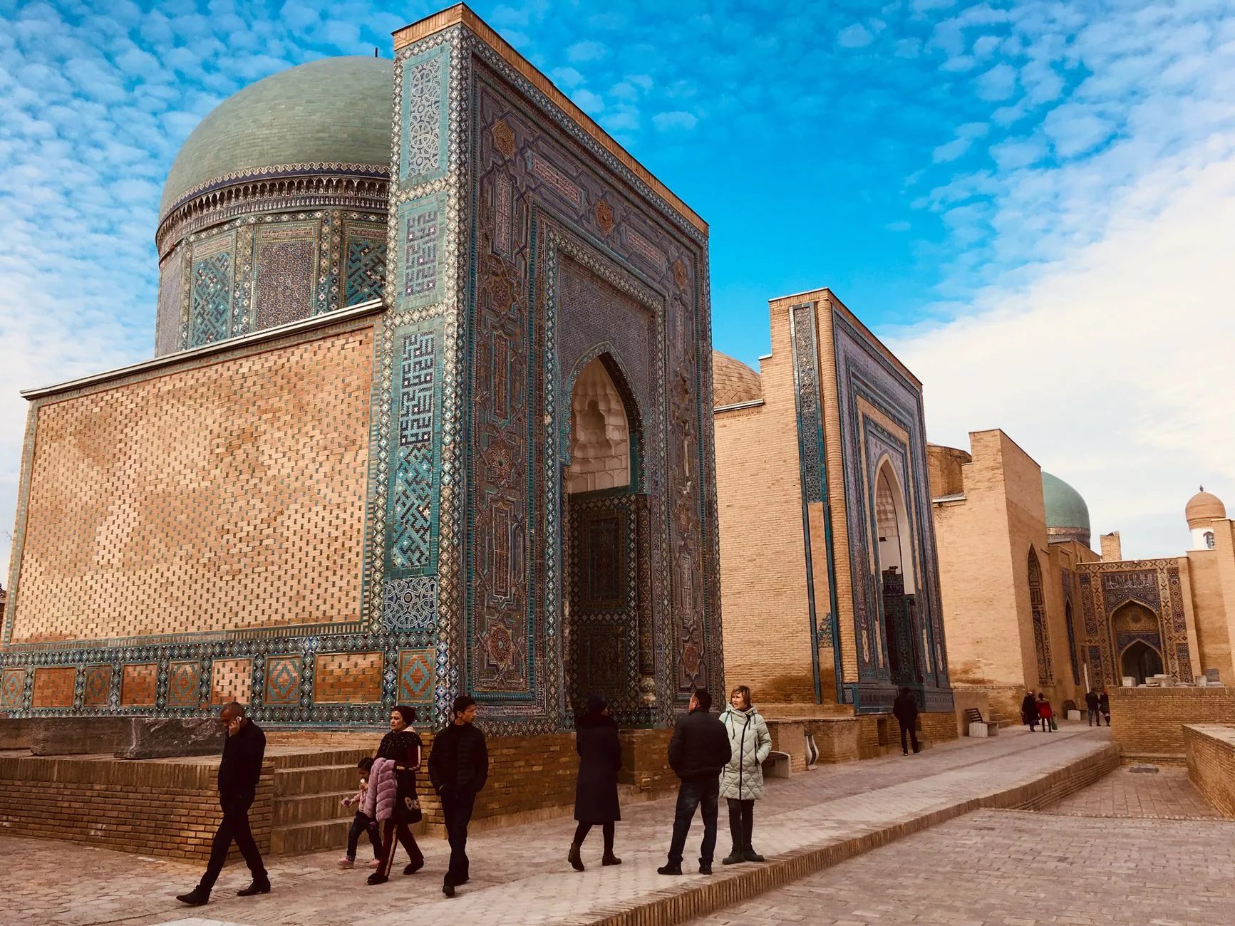 Ornate blue-tiled domes of Samarkand's Registan glowing under a vast Central Asian sky