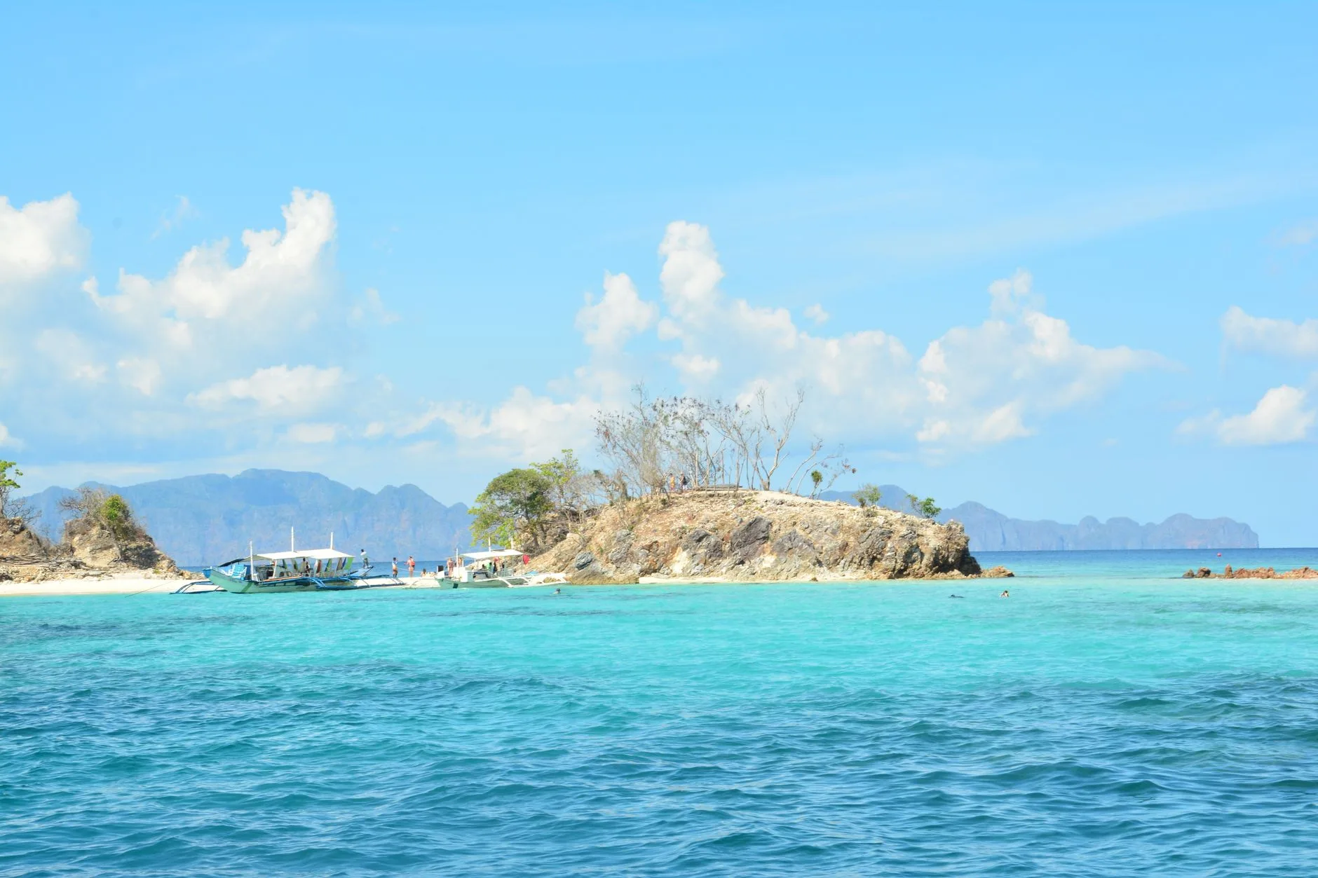 Turquoise waters and lush limestone islands dotting the Philippine archipelago at sunrise