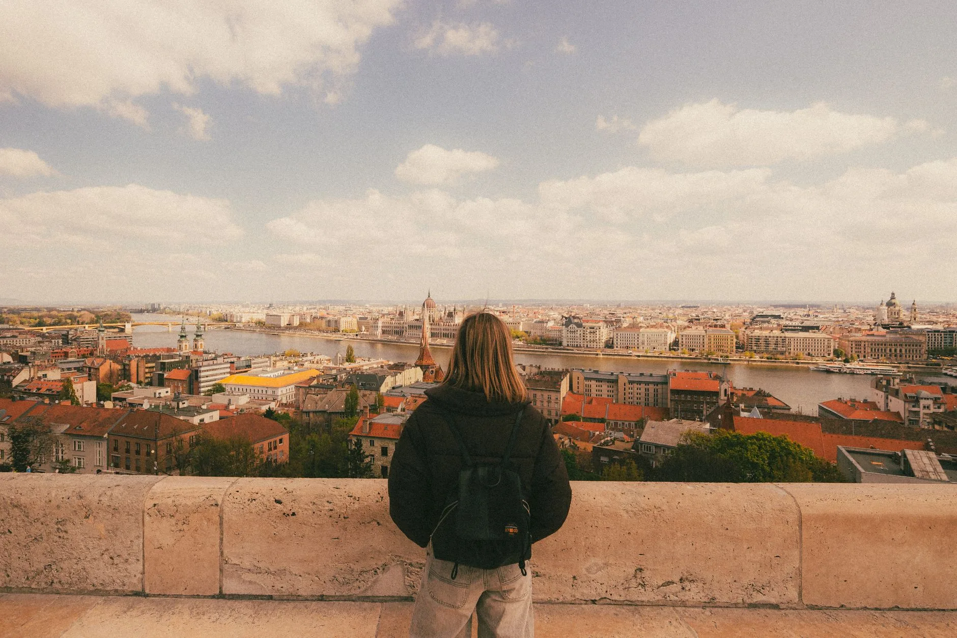 Solo traveler with backpack exploring cobblestone streets of a historic Eastern European city