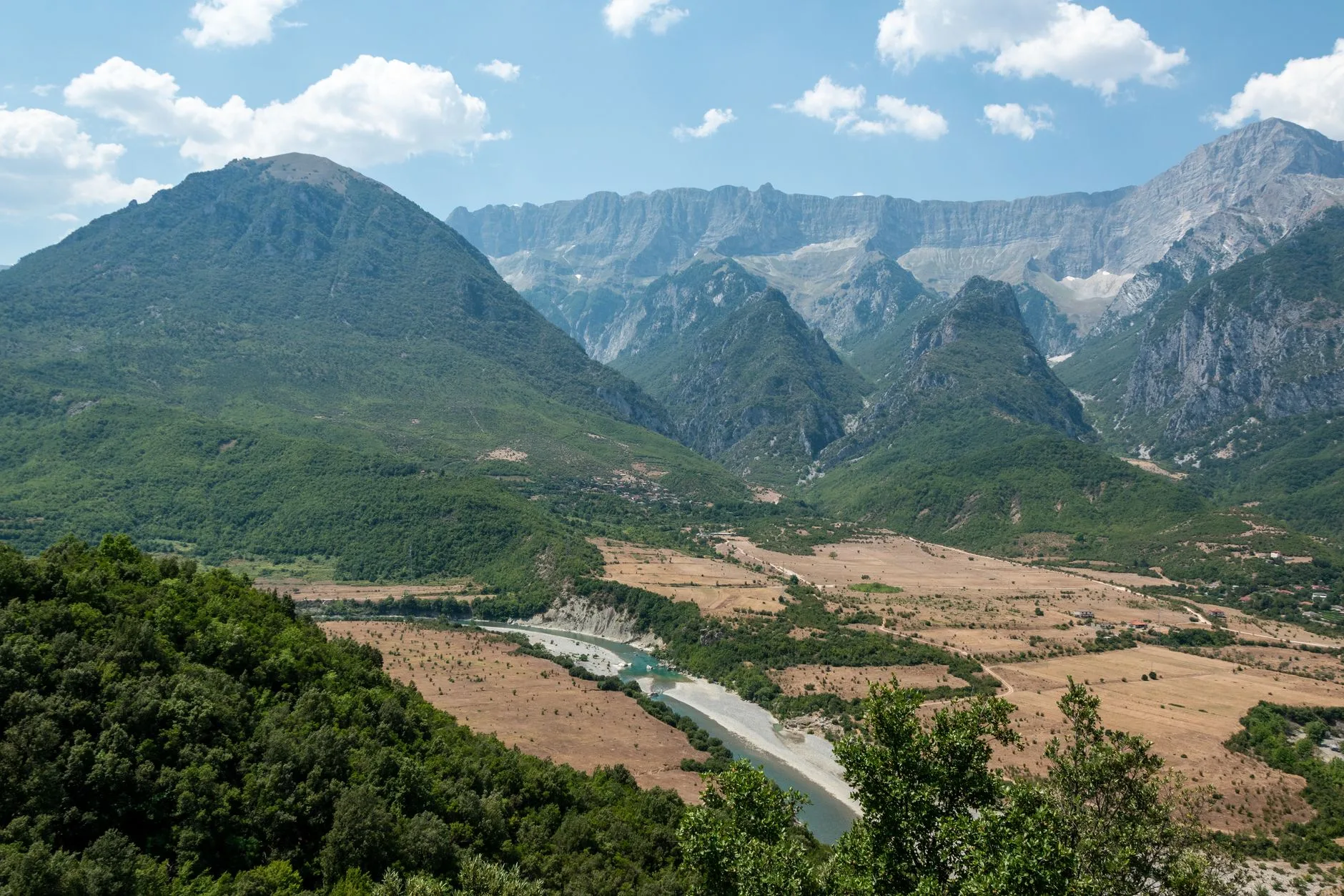 Sunlit Albanian riviera coastline with turquoise waters and rugged cliffs