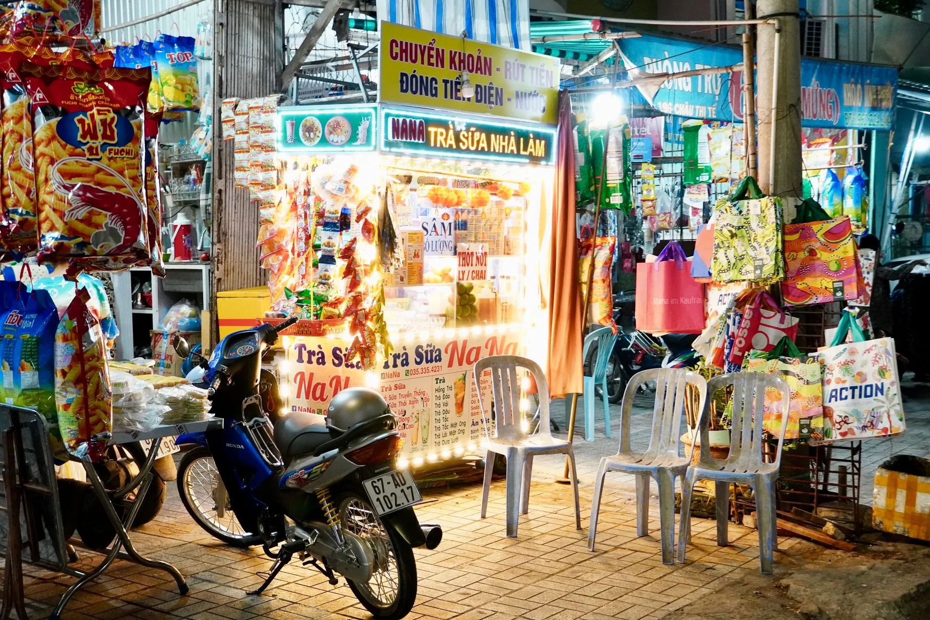 Bustling Vietnamese street market with colorful vendors and motorbikes weaving through narrow lanes