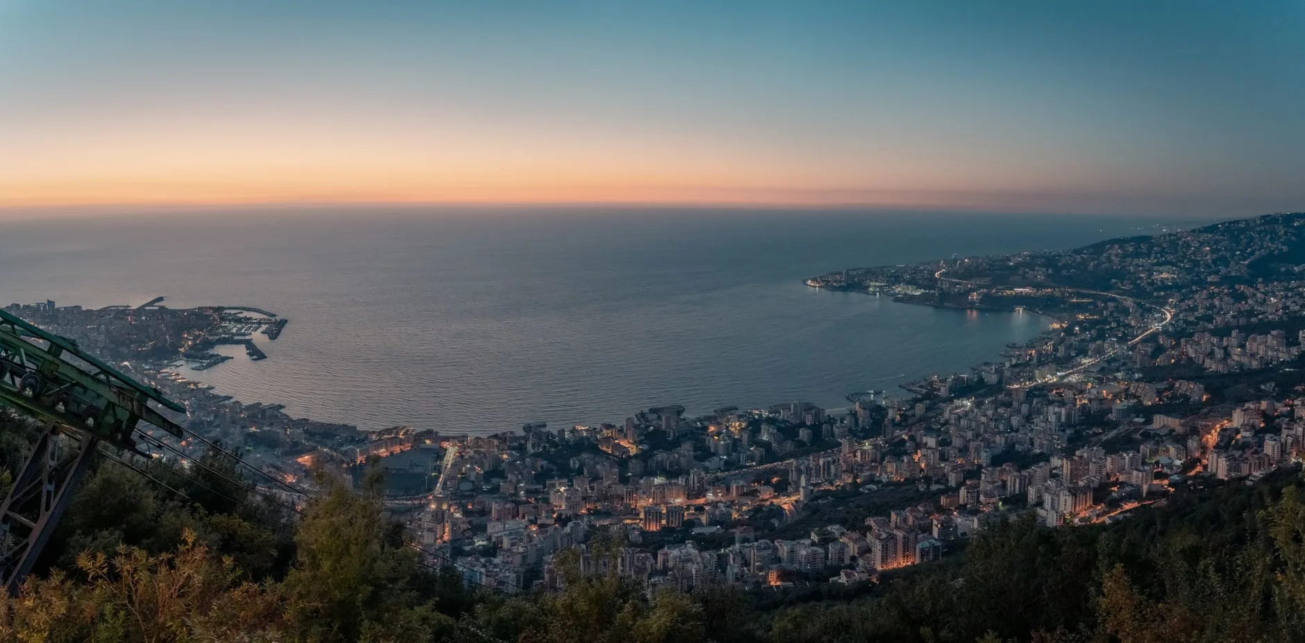 Coastal Lebanese town with terracotta rooftops overlooking the Mediterranean at sunset