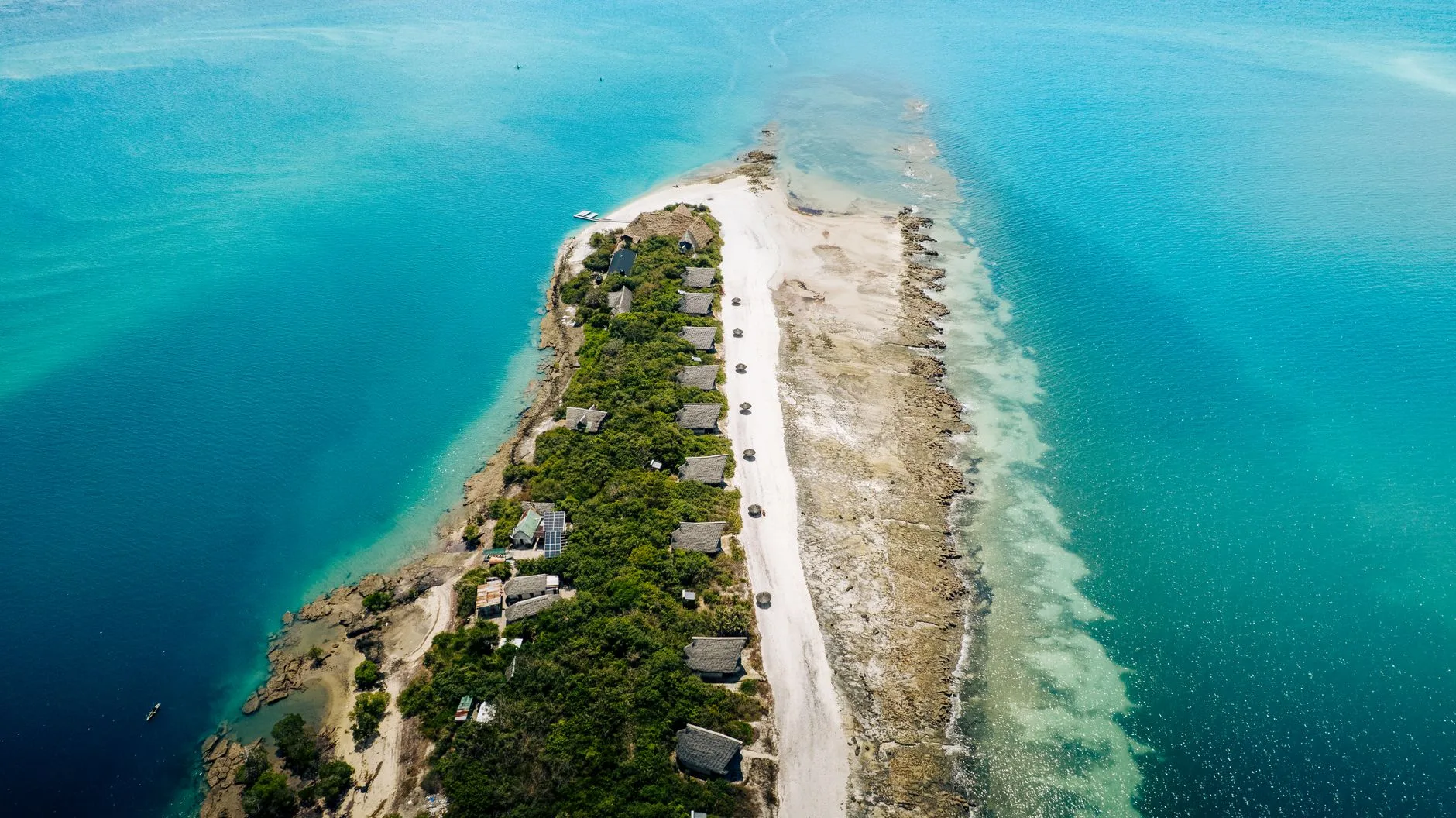 Zanzibar's turquoise coastline with dhow boats, meeting Tanzania's mainland savanna.