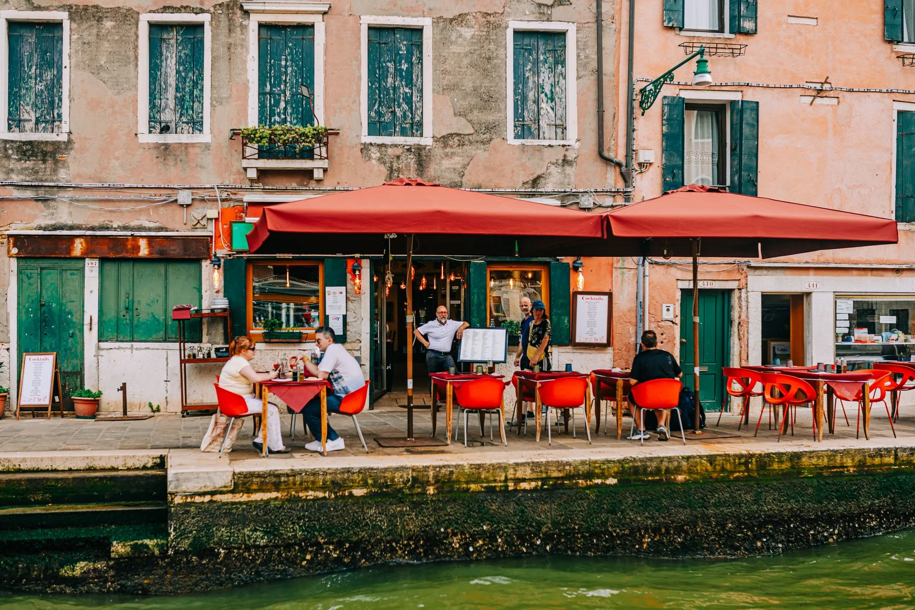 Traveler enjoying a flavorful local dish at a bustling outdoor street market restaurant