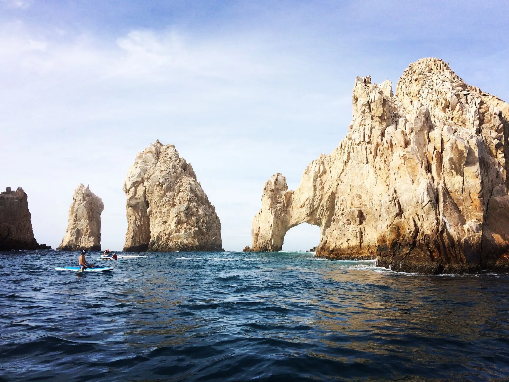 Kayakers paddling turquoise waters along Baja California's rugged Sea of Cortez coastline