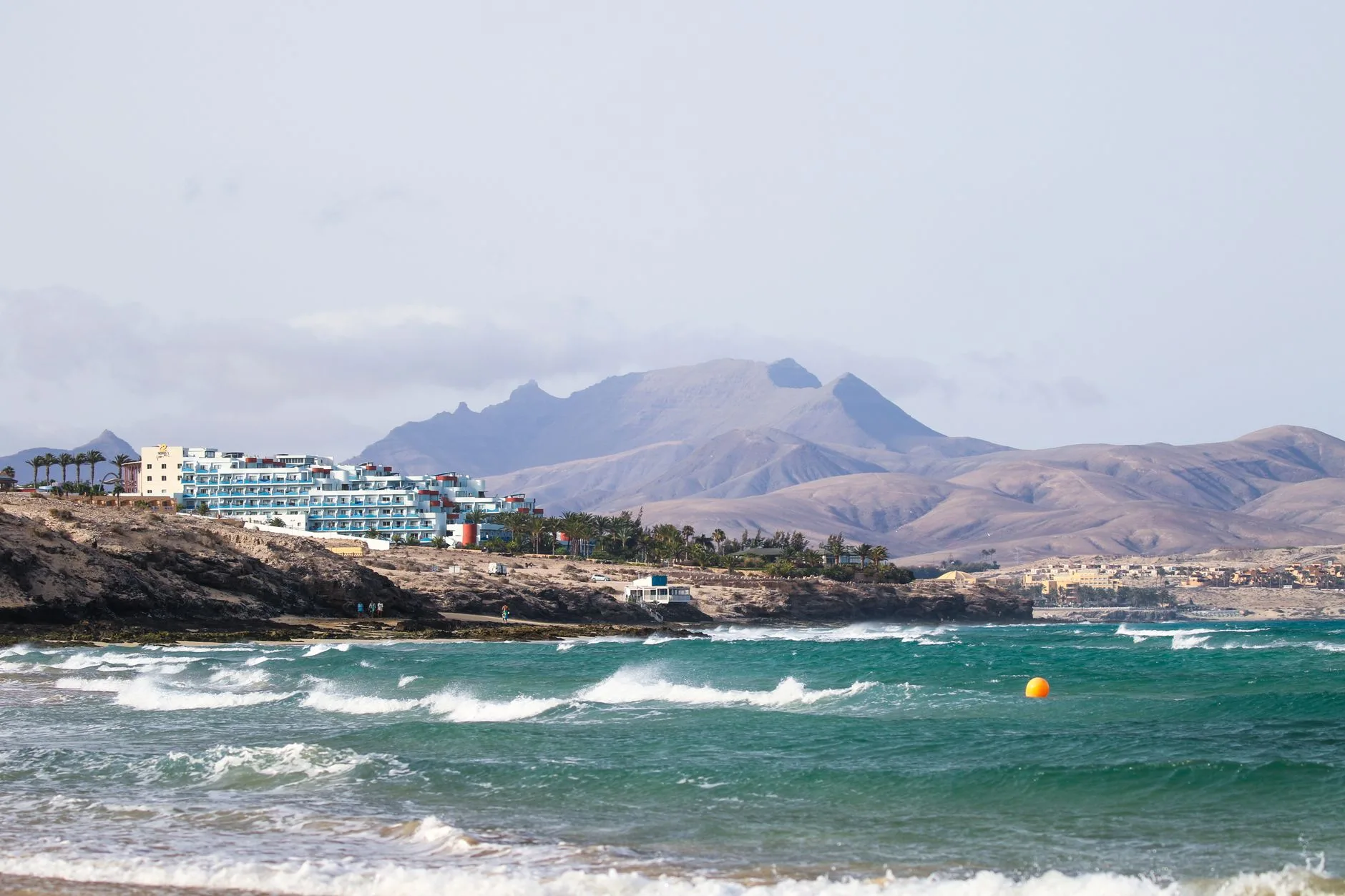 Terraced volcanic hillsides and whitewashed village overlooking the sea in the Canary Islands
