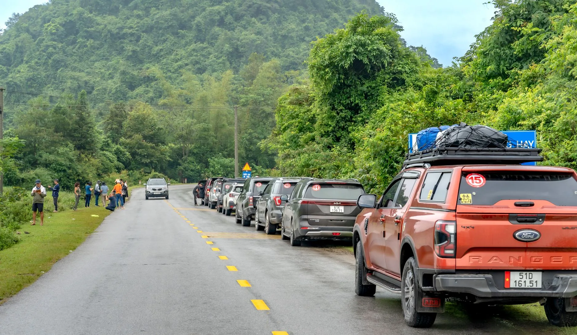 Border crossing gate between Vietnam and Cambodia with flags and passport checkpoint