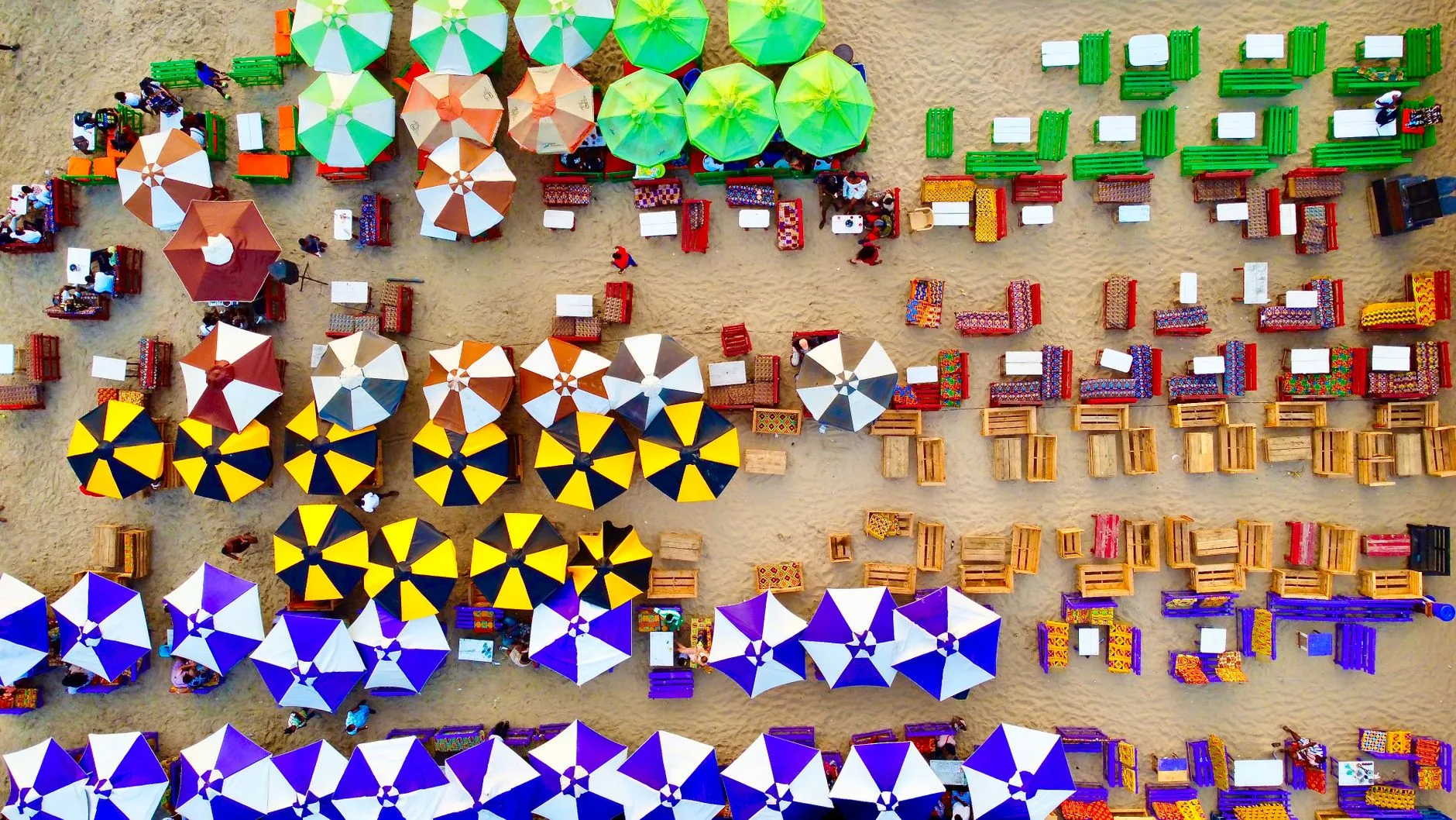 Colorful market stalls and vendors lining a bustling street in Ghana, West Africa