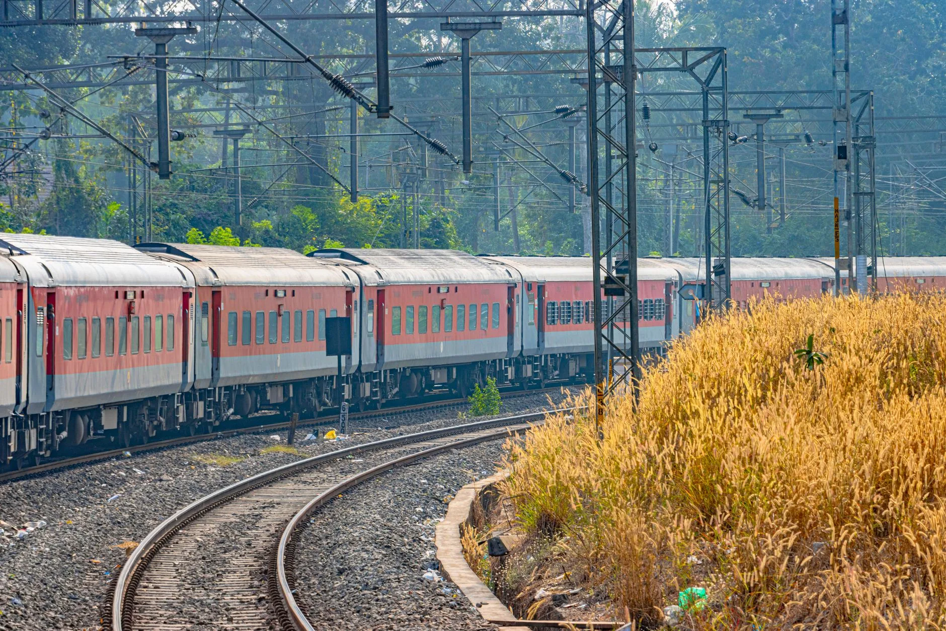 Indian train winding through countryside, connecting northern hills to southern coastal plains