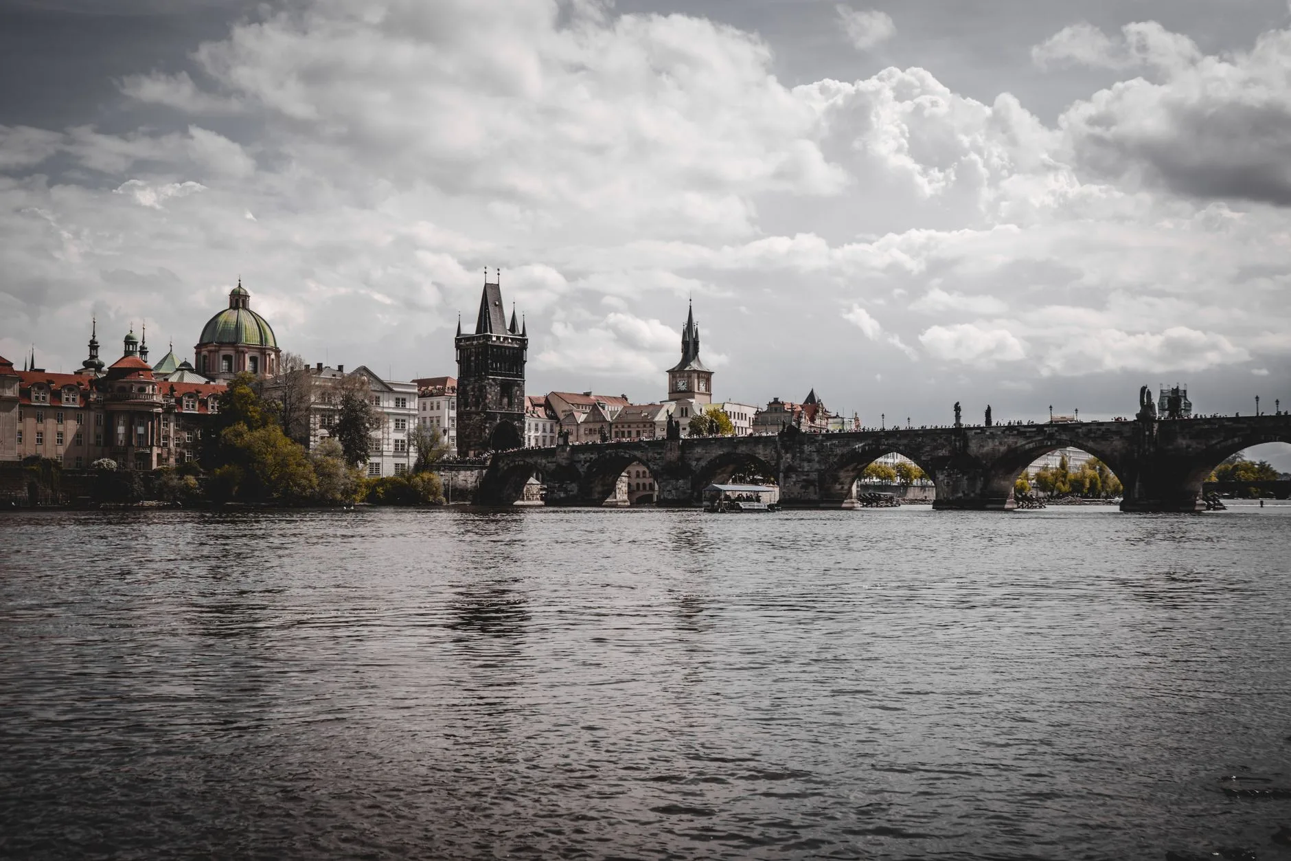 Historic Czech town square with colorful buildings, cobblestone streets, and castle spires