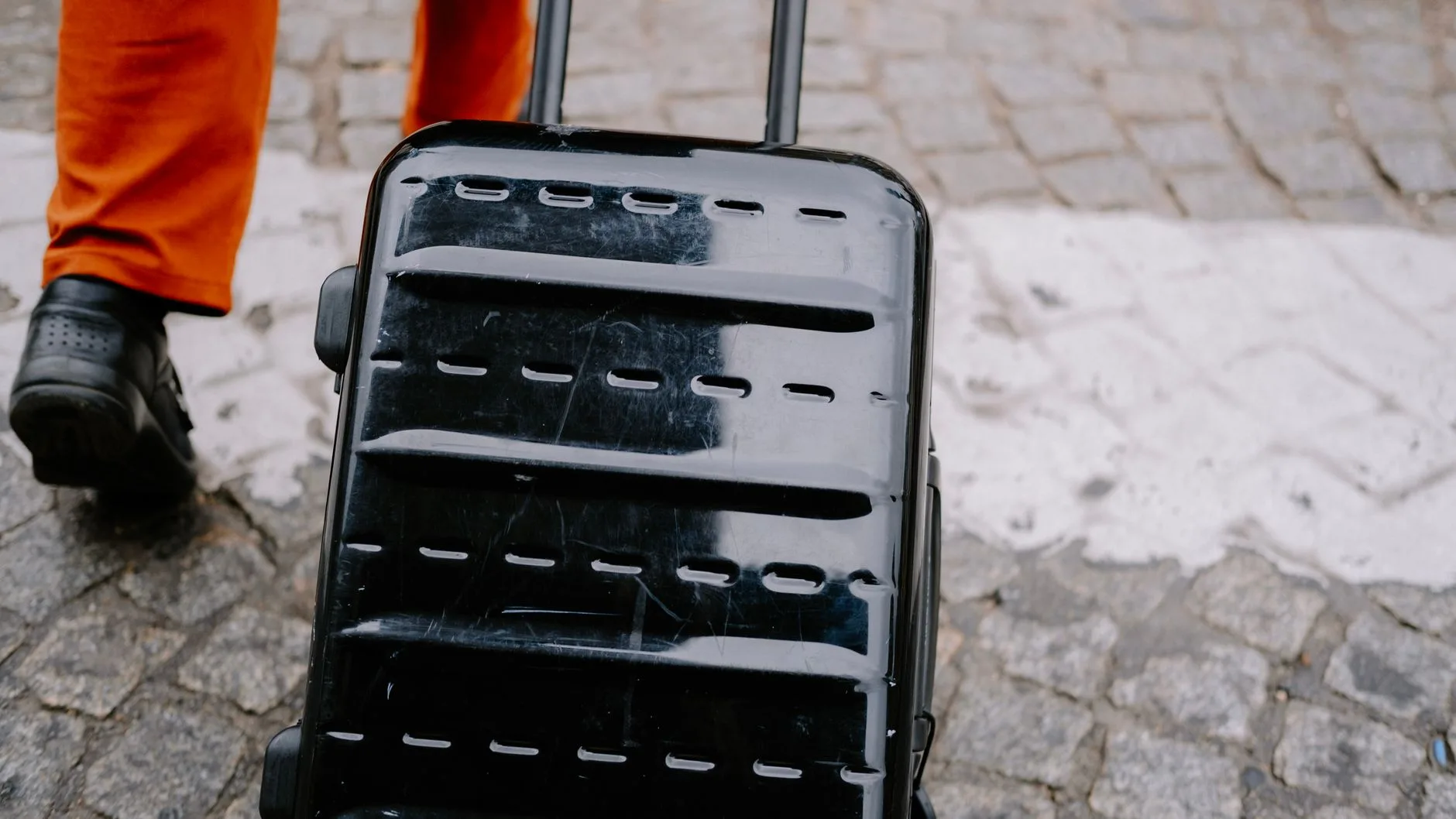 Packed carry-on suitcase and backpack ready by the door for a trip