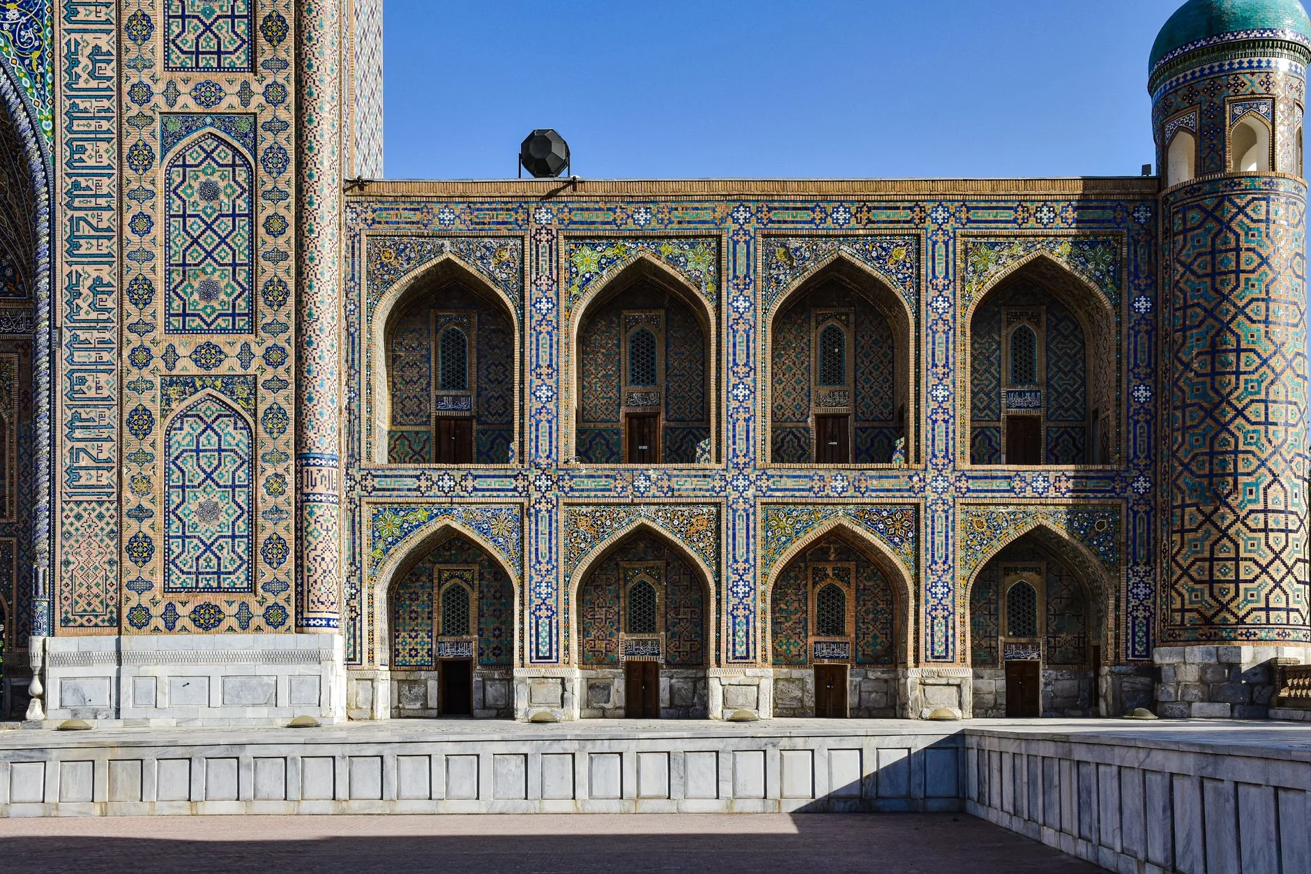 Silk Road mountains and traditional yurts beneath a vast Central Asian sky