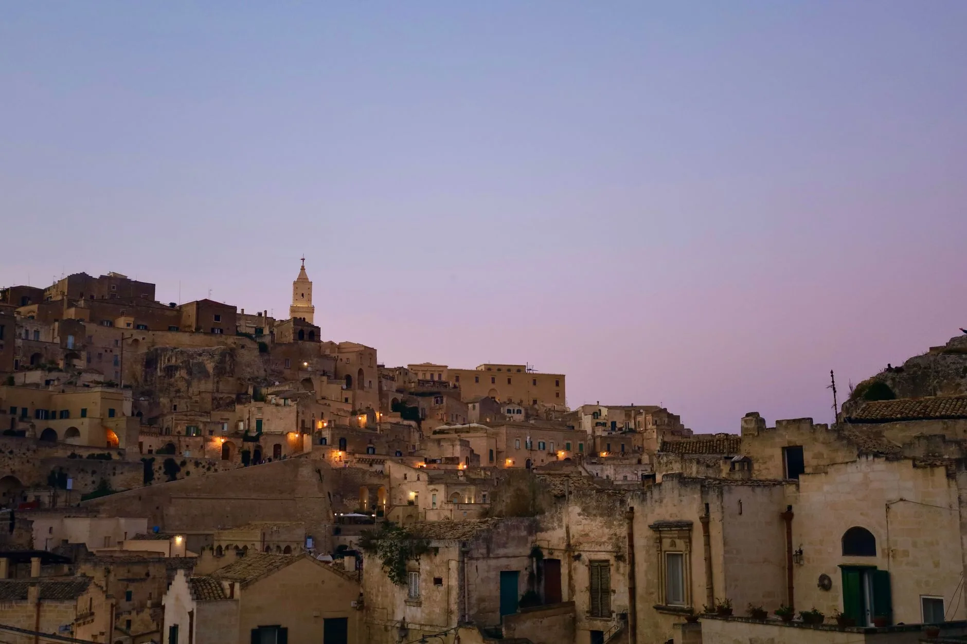 Coastal village clinging to cliffs above turquoise sea in Calabria, southern Italy